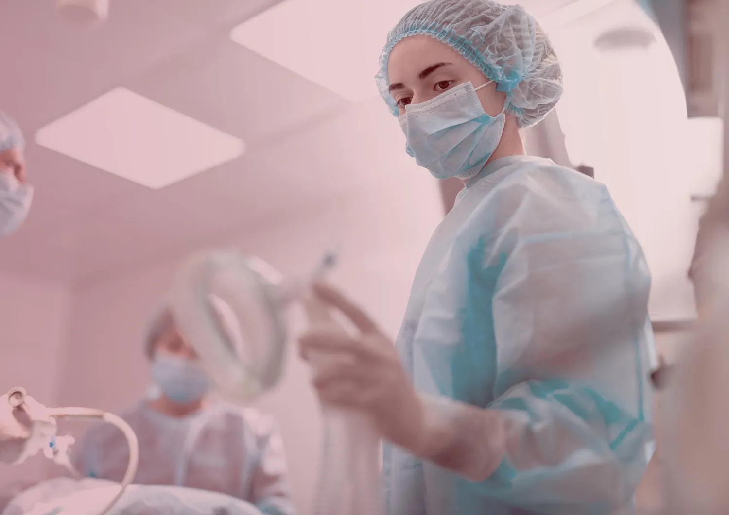 Woman in scrubs in hospital at a job she got due to her ER nurse resume.