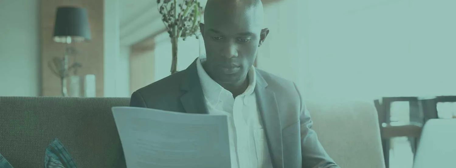 A man at a desk exploring resume examples on a laptop.