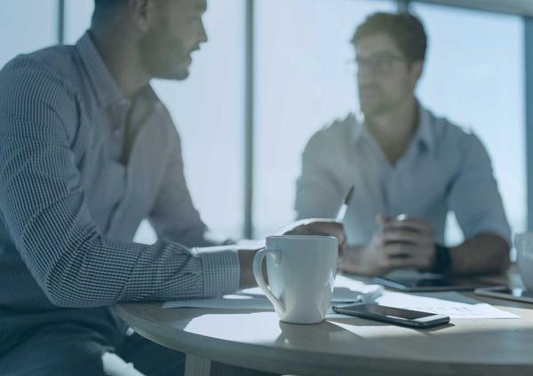 Two people in an office engaged in job interview questions and answers.