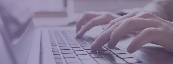 Fingers typing on a keyboard using our resume cover letter builder.