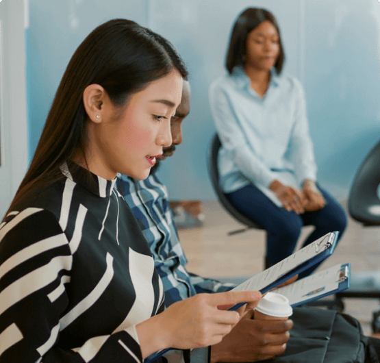 Excited woman holding a resume example and a trophy.
