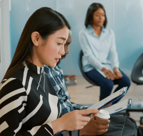 Excited woman holding a resume.